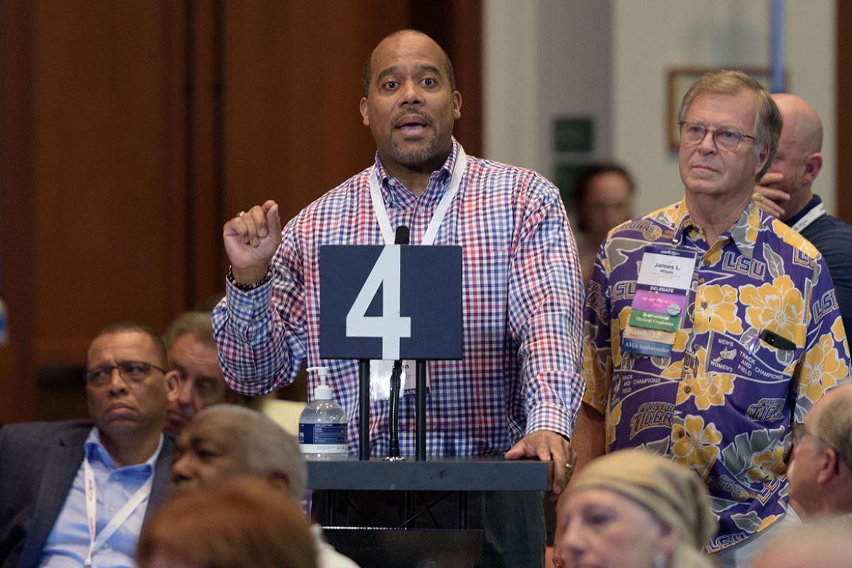 Person speaking at a microphone at the 2022 Interim Meeting