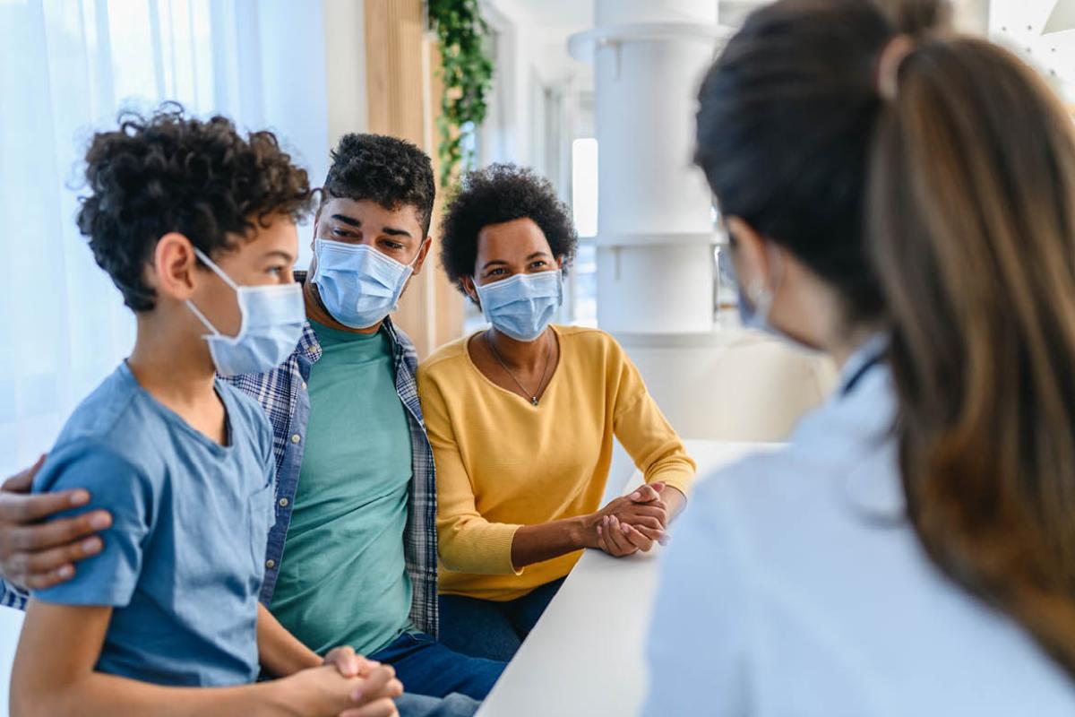 Family speaking with health care worker