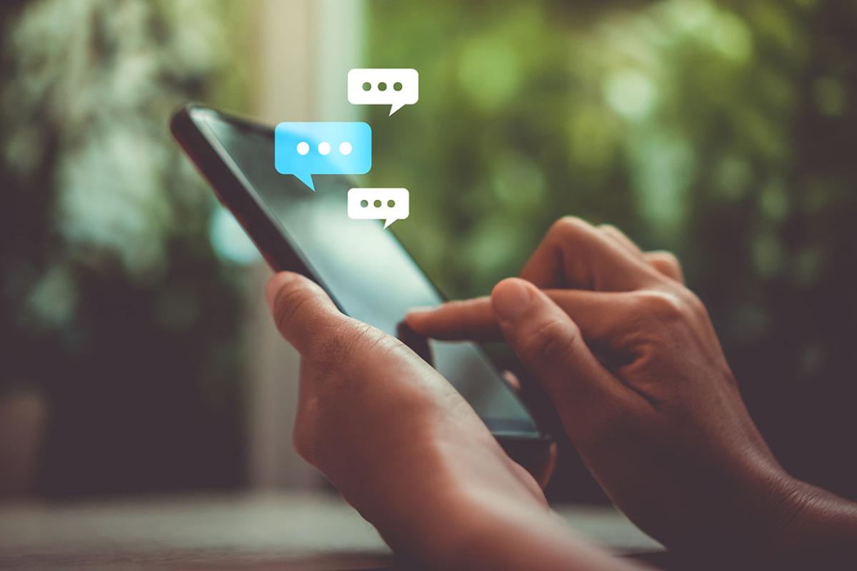 Person using mobile phone with speech bubbles