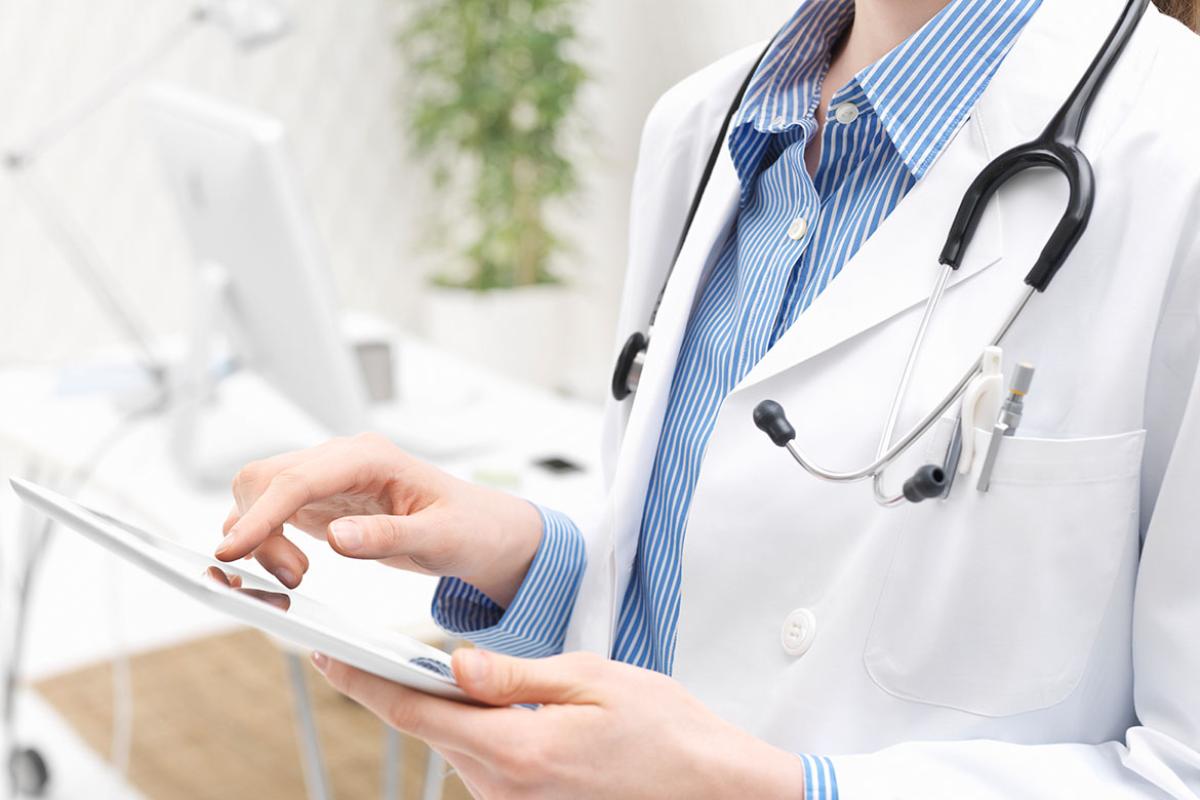 Health care worker using a tablet
