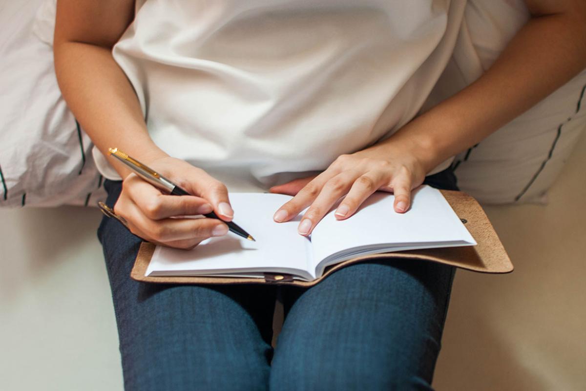 Someone about to write on an empty journal
