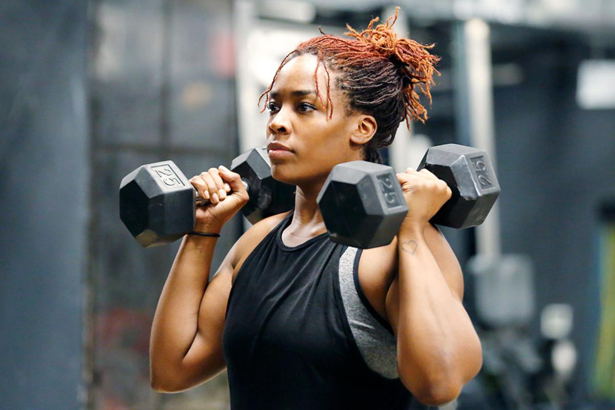 Person in a gym lifting weights