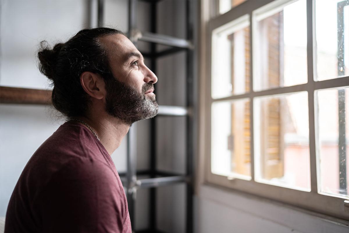Profile of smiling person looking out the window