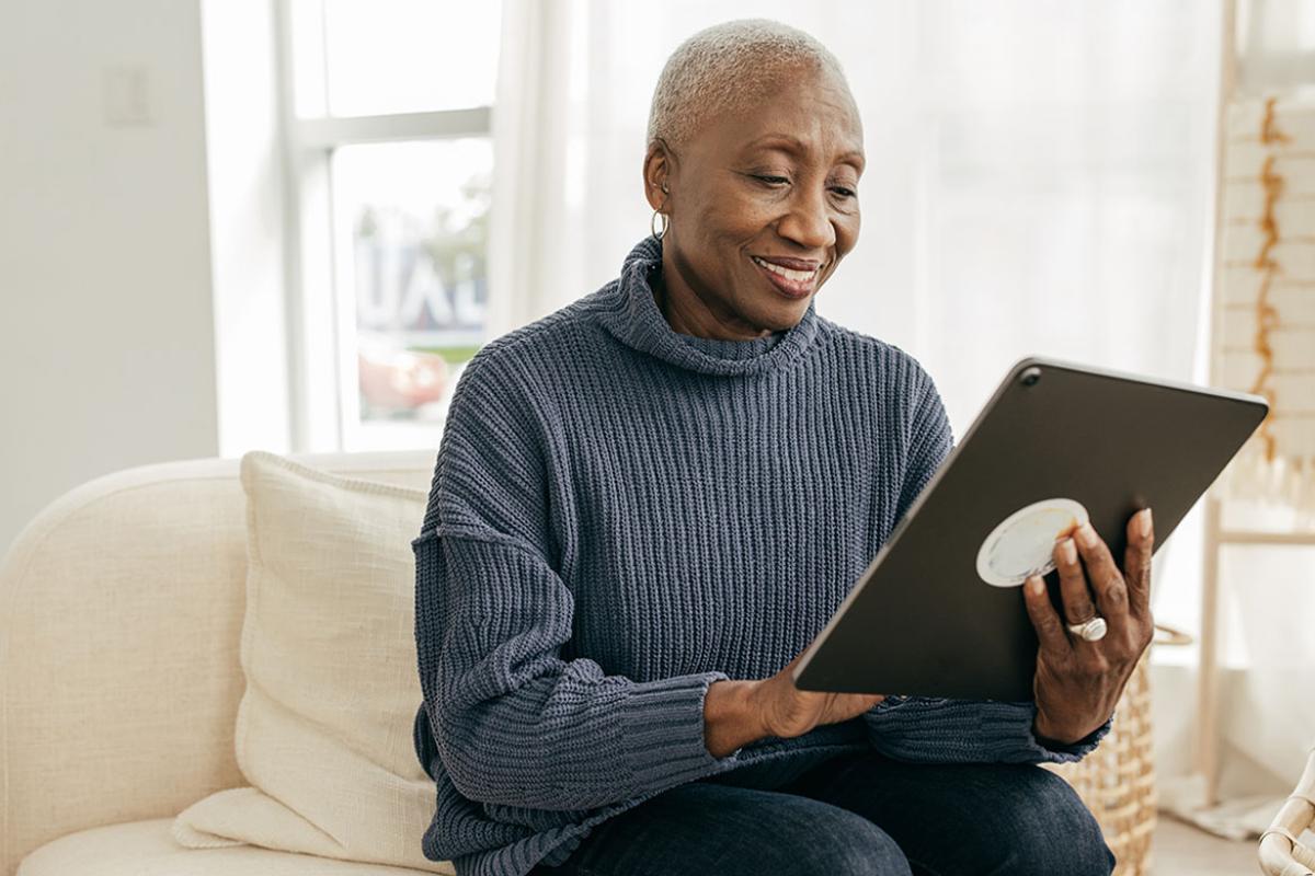 Smiling person working on a tablet