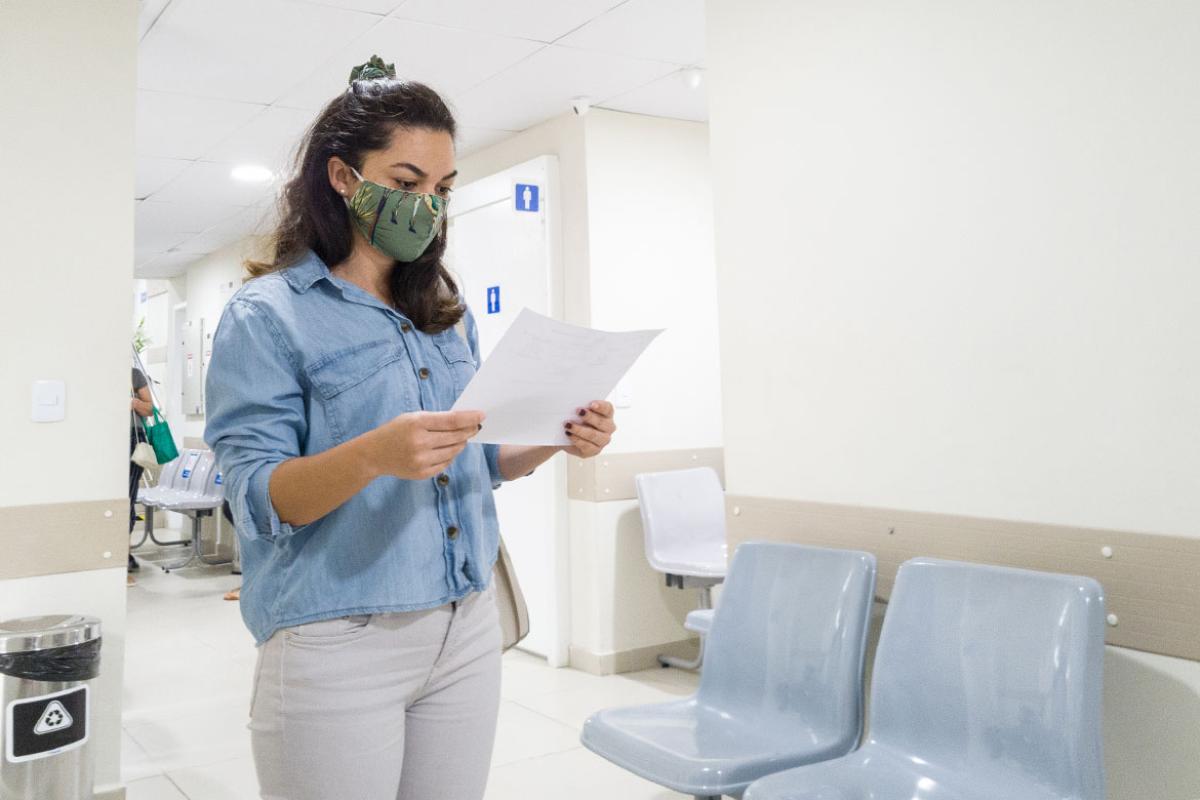 Patient reading papers at medical clinic