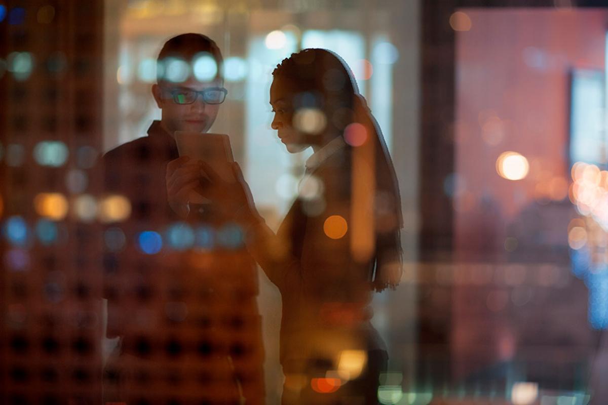 Two people looking at tablet in office