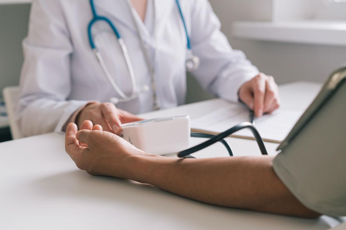 Patient having blood pressure taken during checkup
