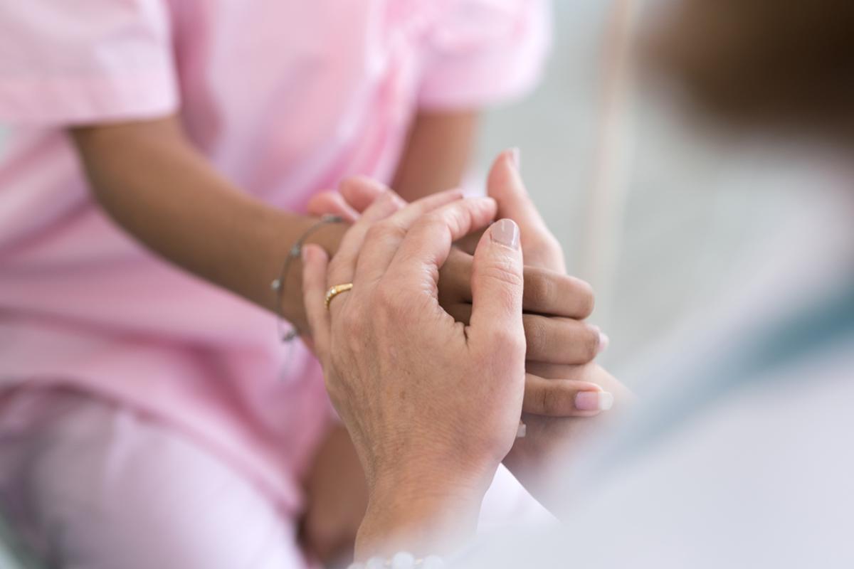 Doctor holding patient's hand