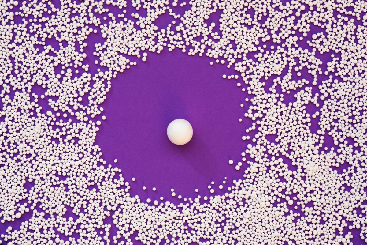 Large group of small balls with a larger ball in the center