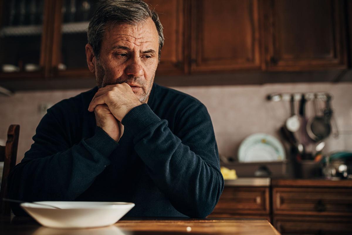 Forlorn person sitting at a table
