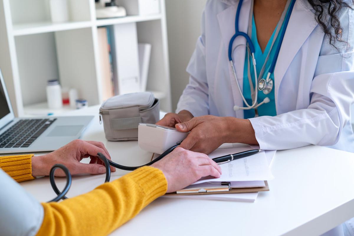 Physician taking patient's blood pressure