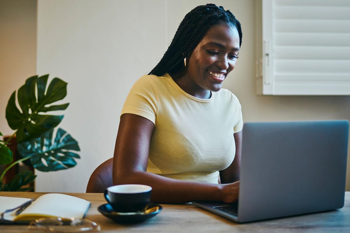 Smiling person working at laptop