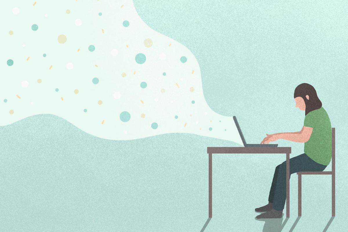 Figure at a desk working on a laptop