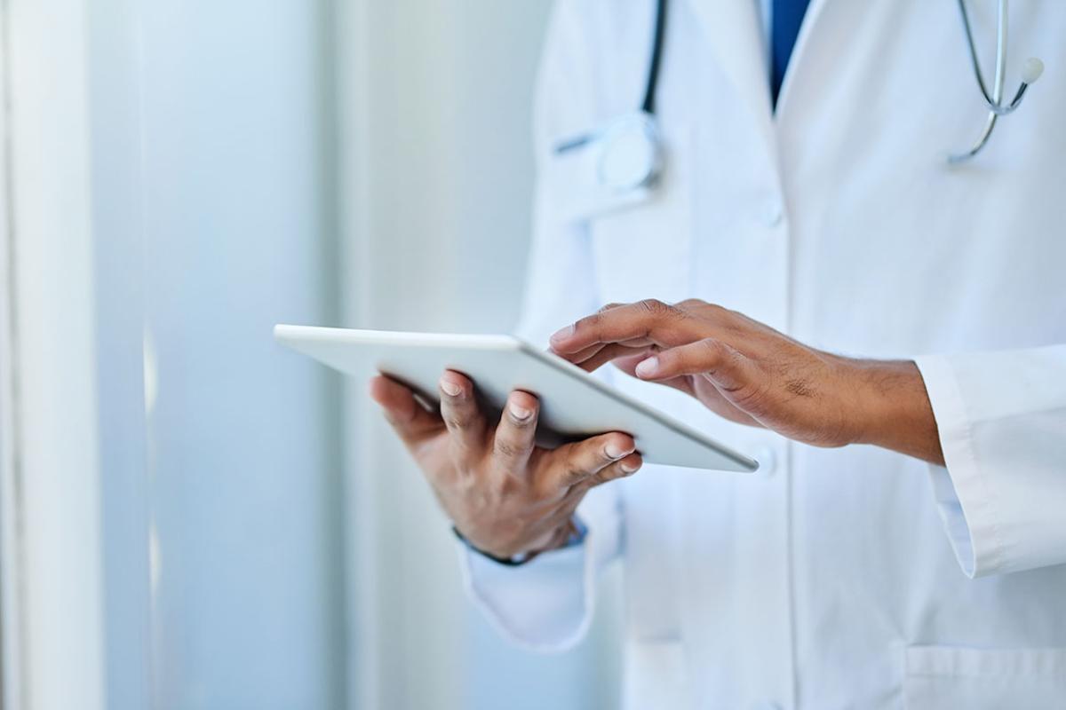 Physician scrolling on a tablet
