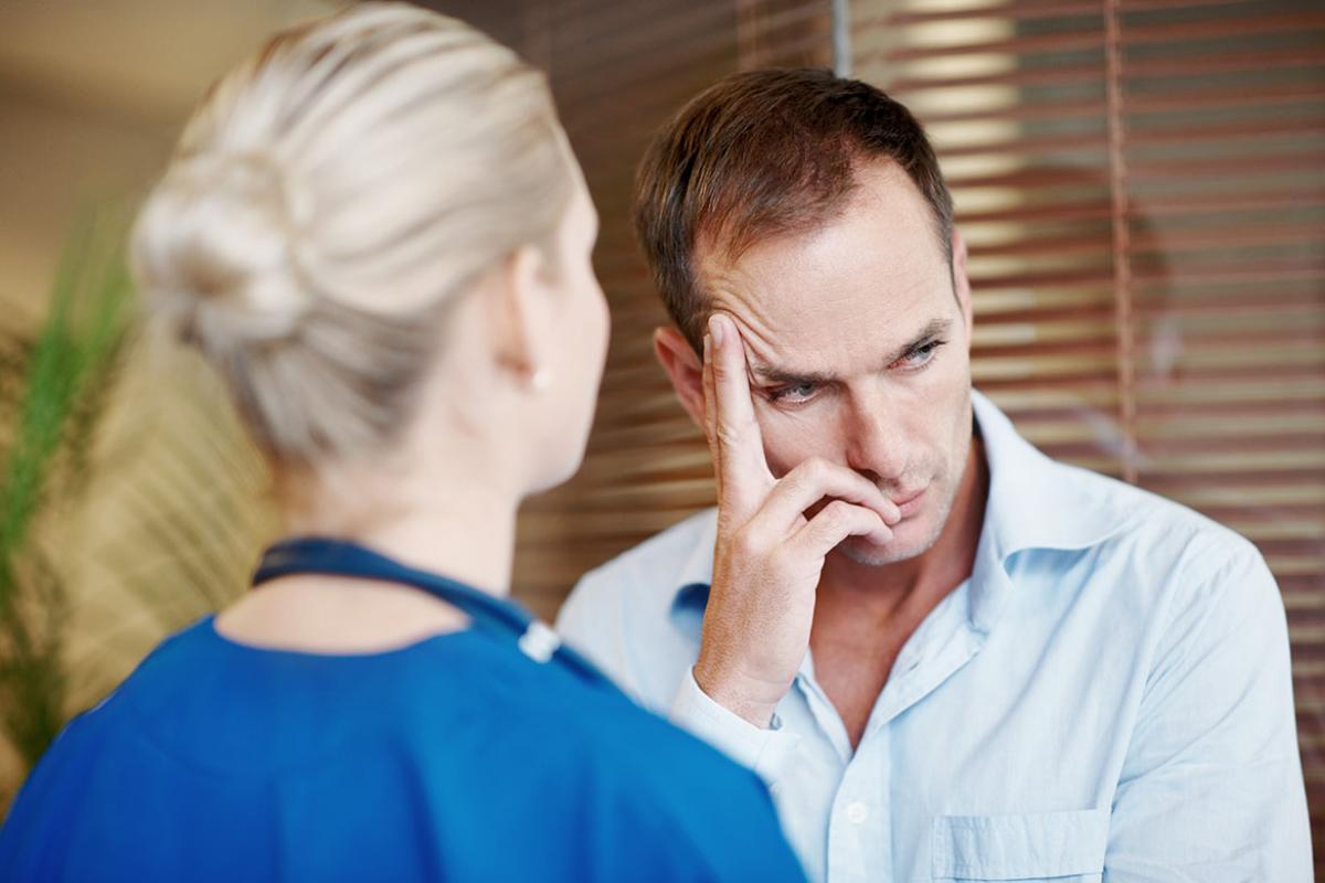 Person with a concerned look, head in hand