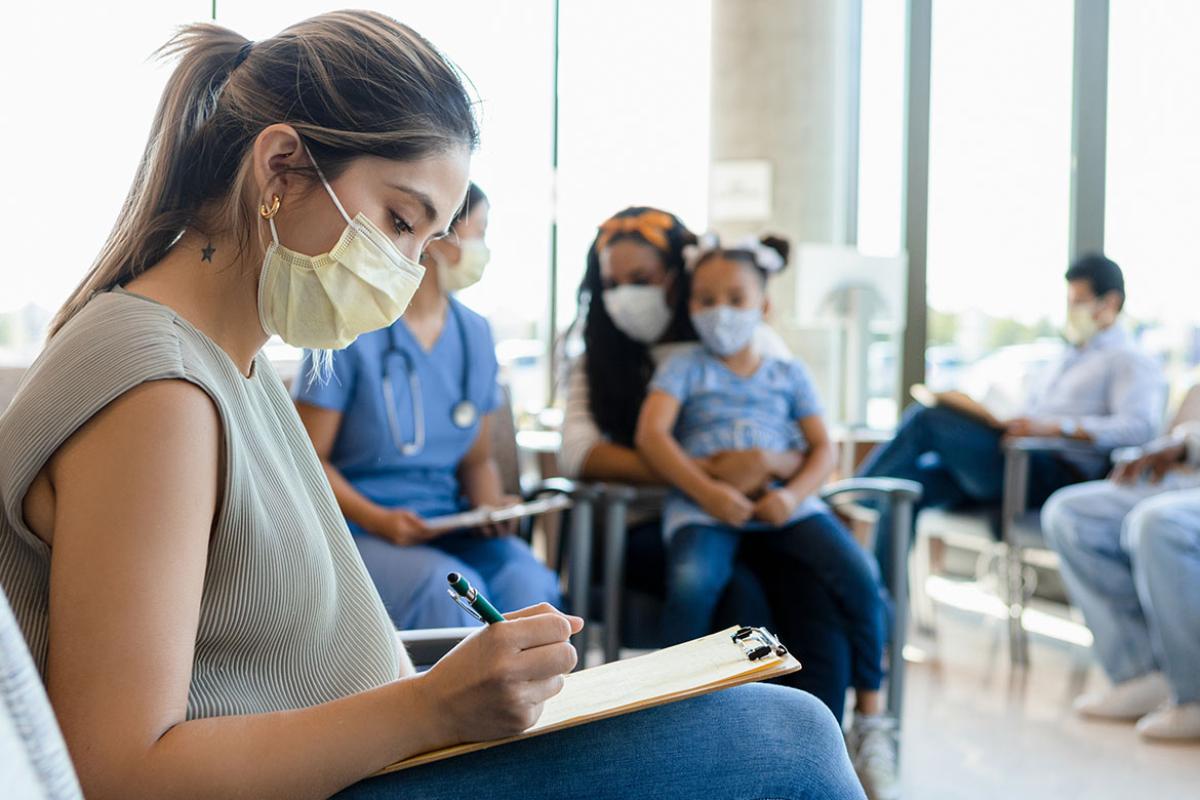 Person filling on a form in a waiting room