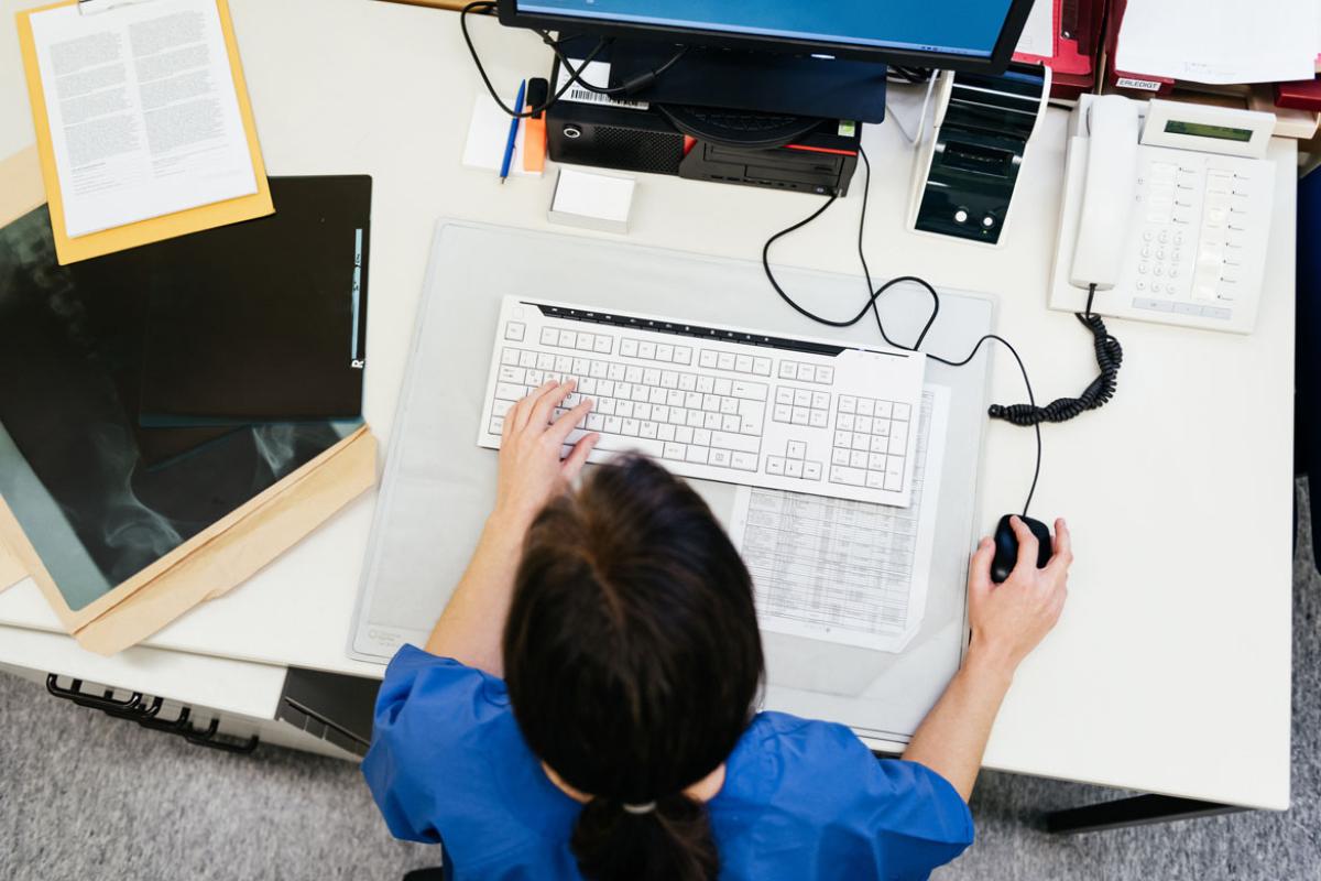 Overhead view of a health care worker at a computer
