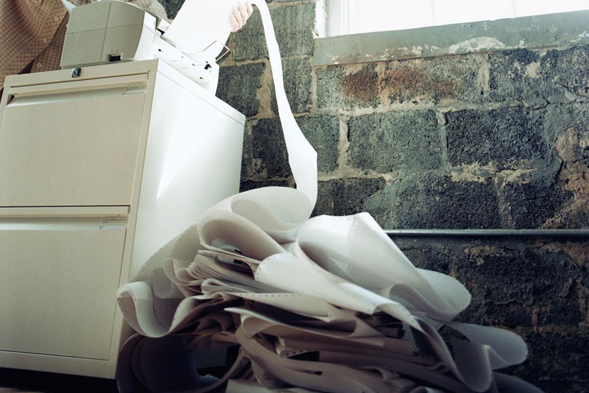 Paper spilling out of a fax machine