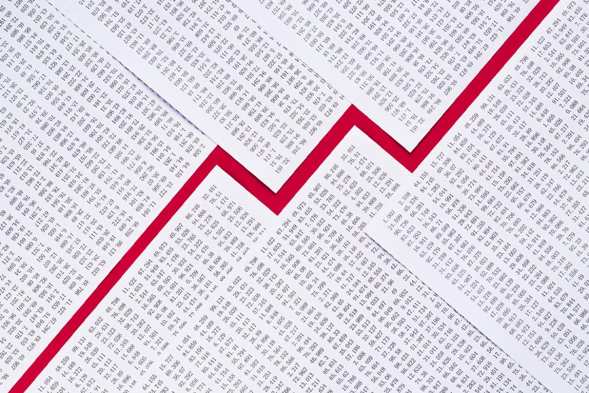 Columns of financial numbers and red line chart trending upwards