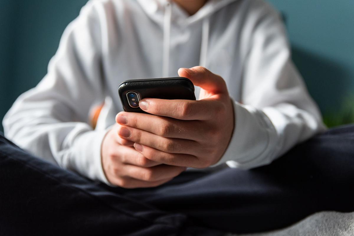 Hands holding mobile phone