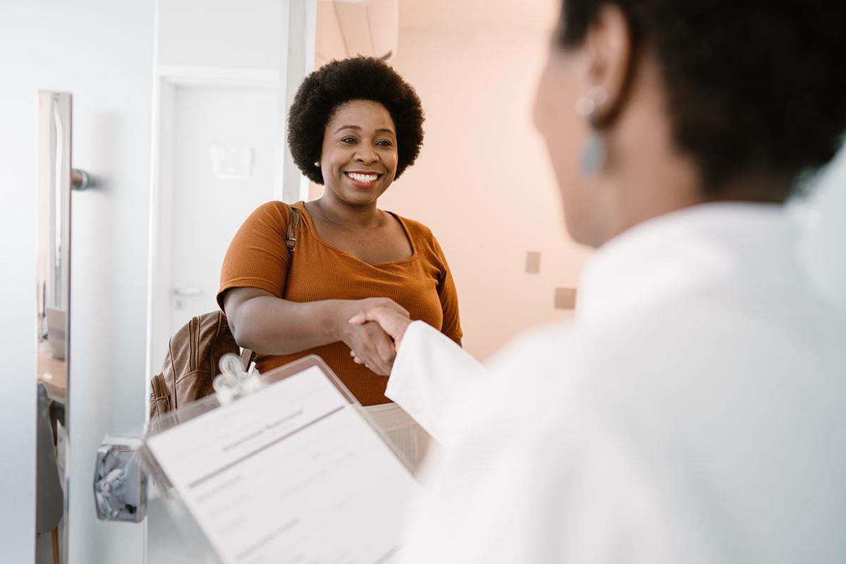 Physician greeting a female African American patient