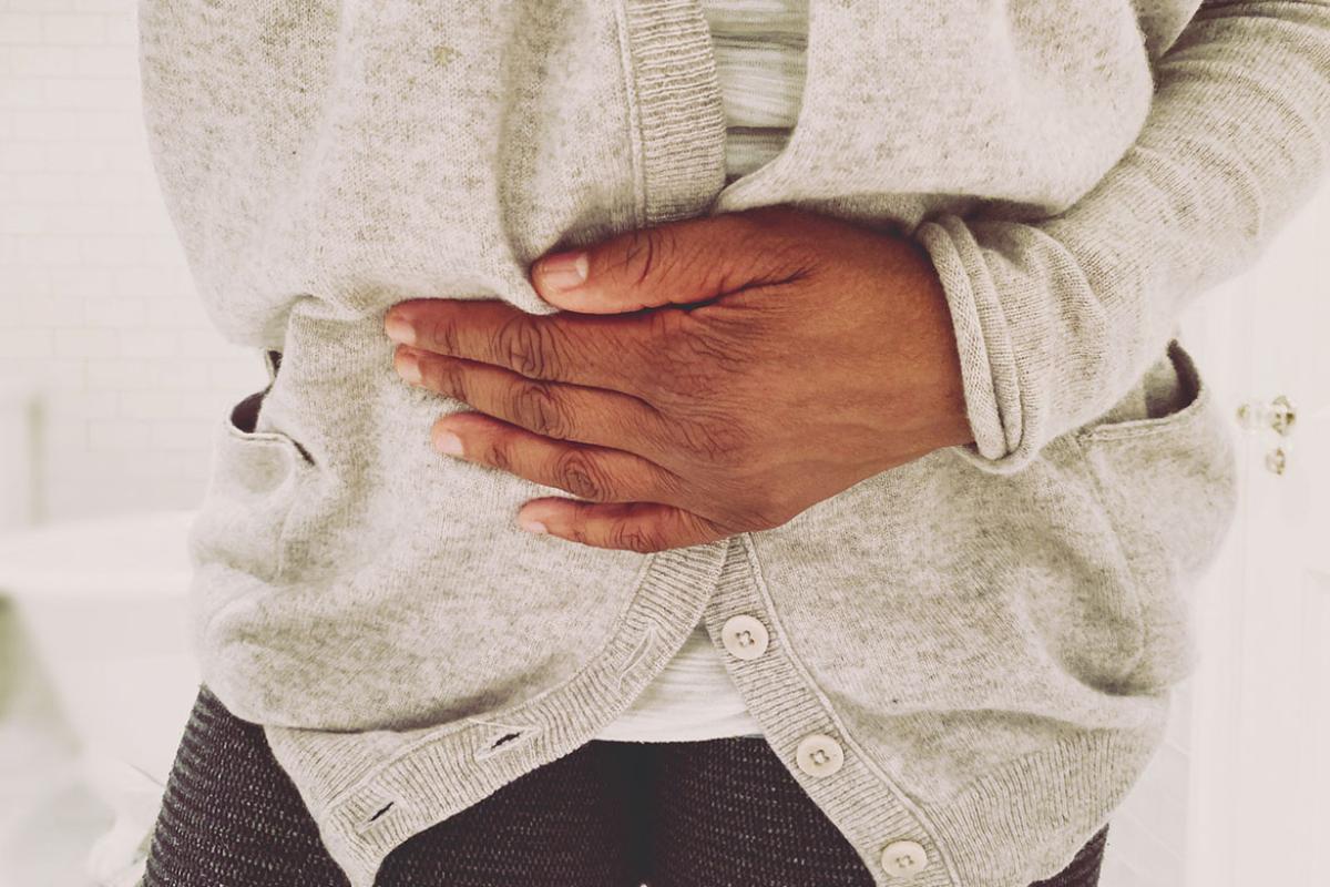 Person's hand on their midsection