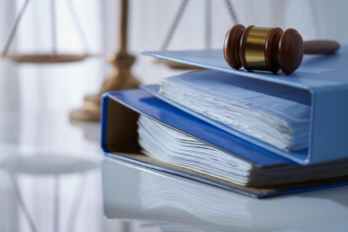 Gavel hammer on stack of documents