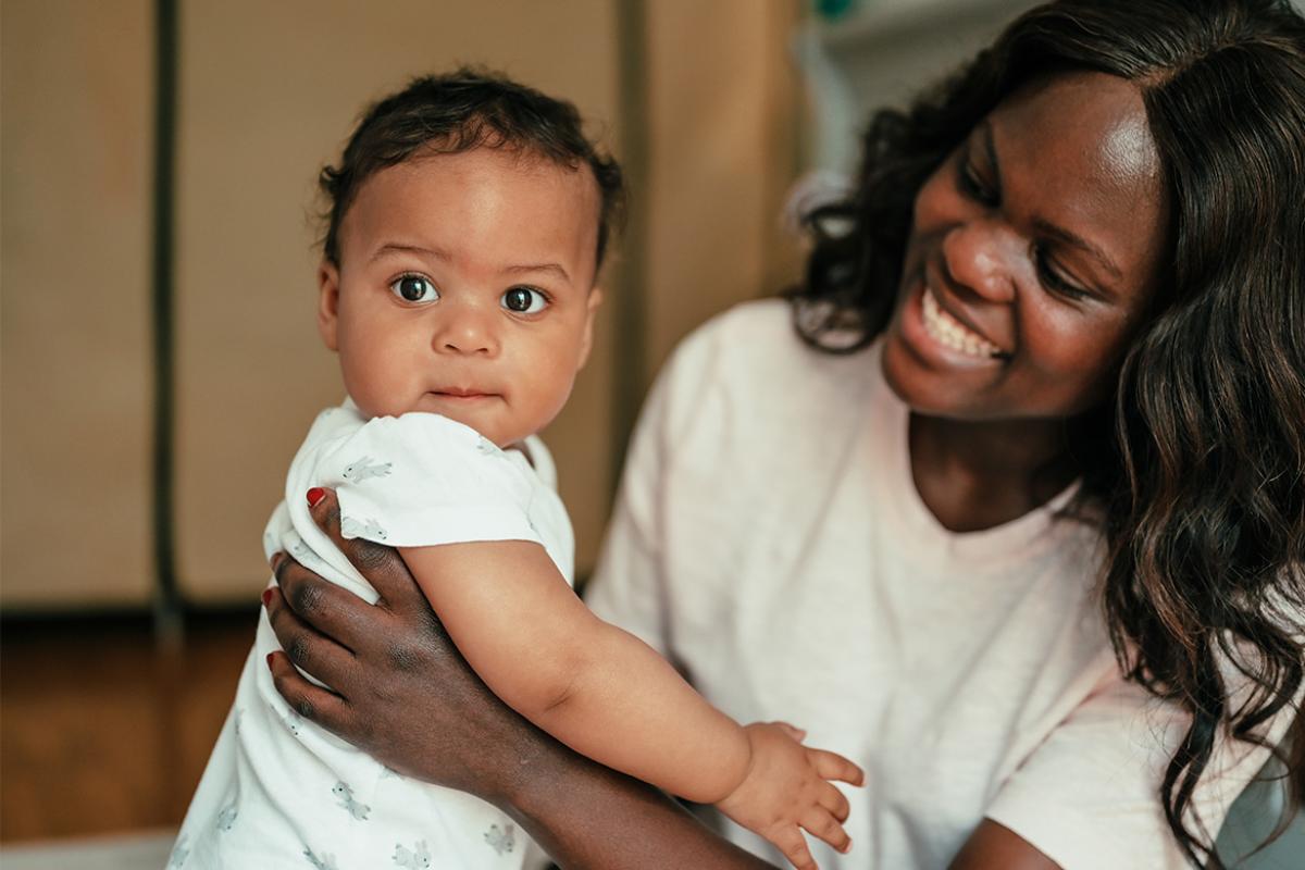 Smiling mother holding baby
