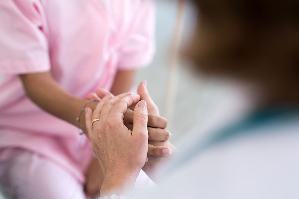 Doctor holding a patient's hand