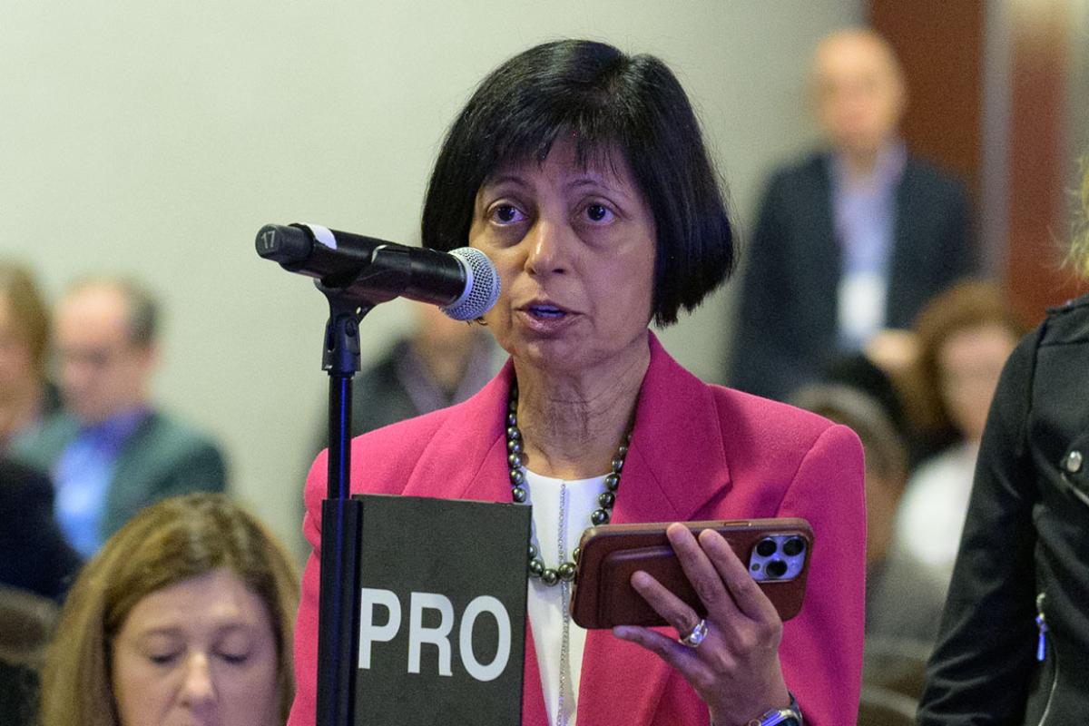 Delegate holding phone and speaking at the 2023 Annual Meeting