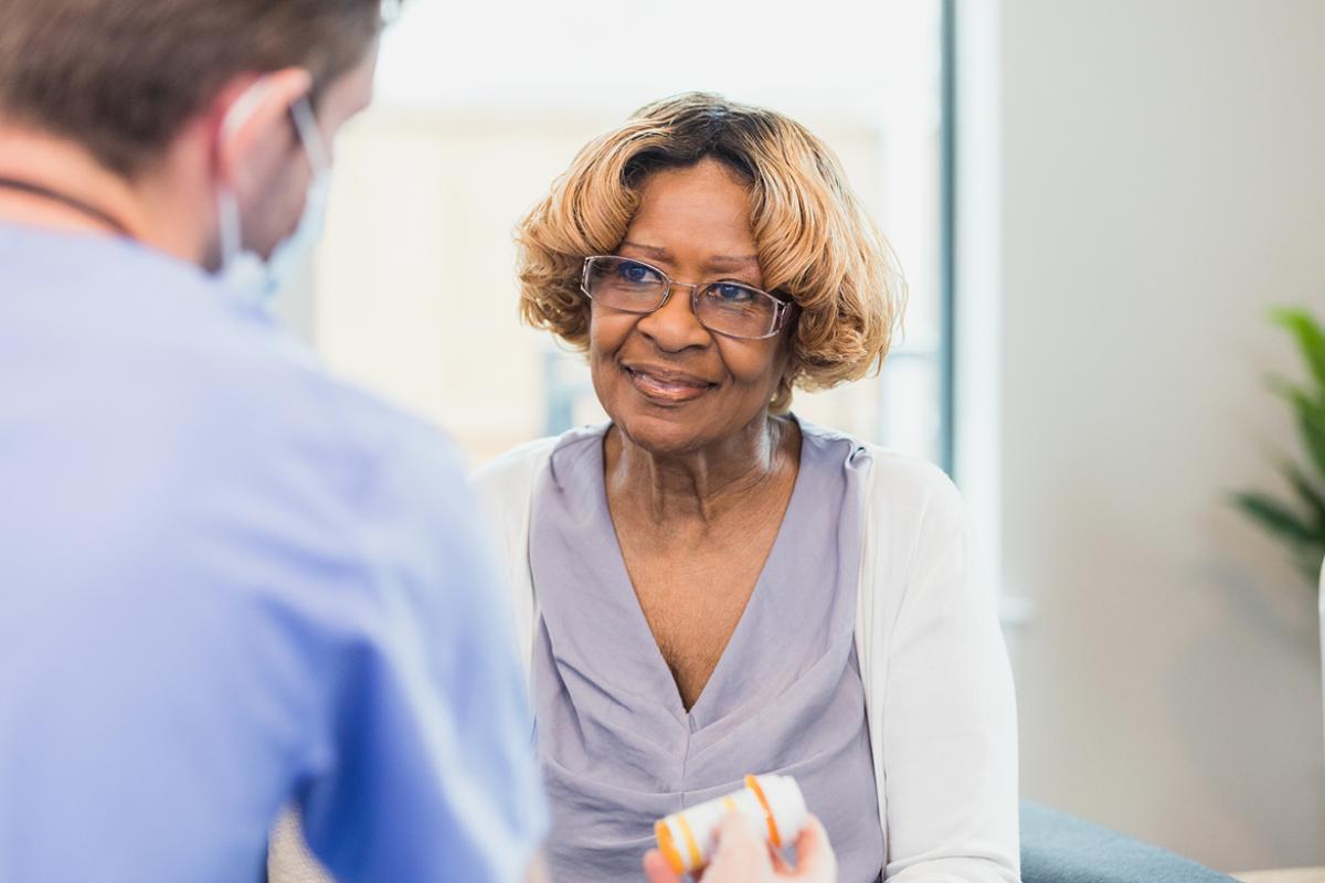Smiling patient speaking with health care worker