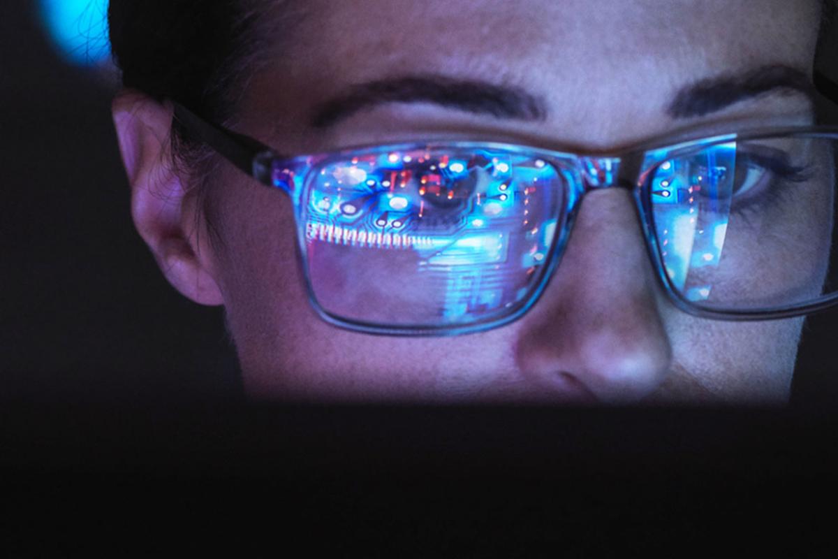 Computer screen reflected in a person's glasses