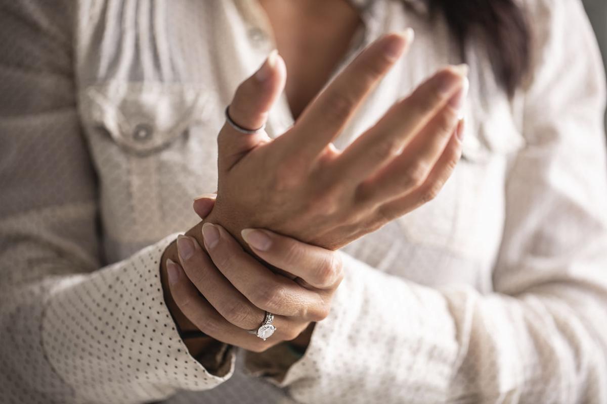 Person holding their wrist
