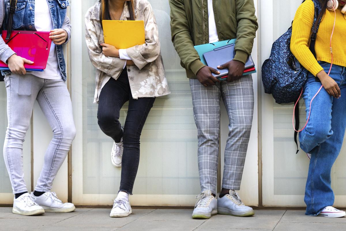 Group of teenagers standing in a line at school