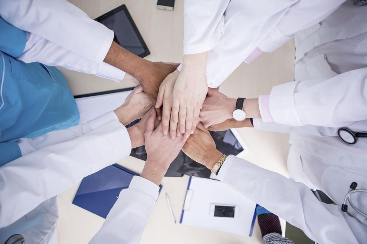 Colleagues putting hands together