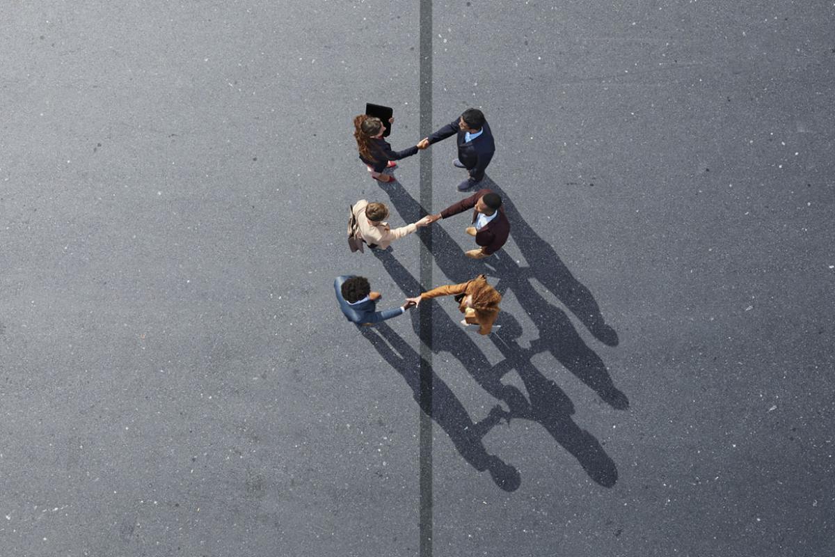 Group of six people shaking hands