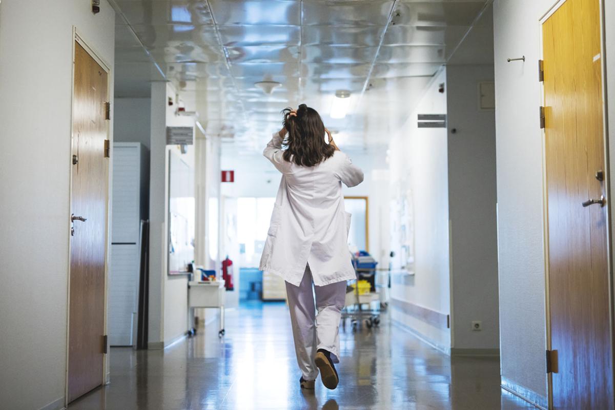 Physician walking down a hallway
