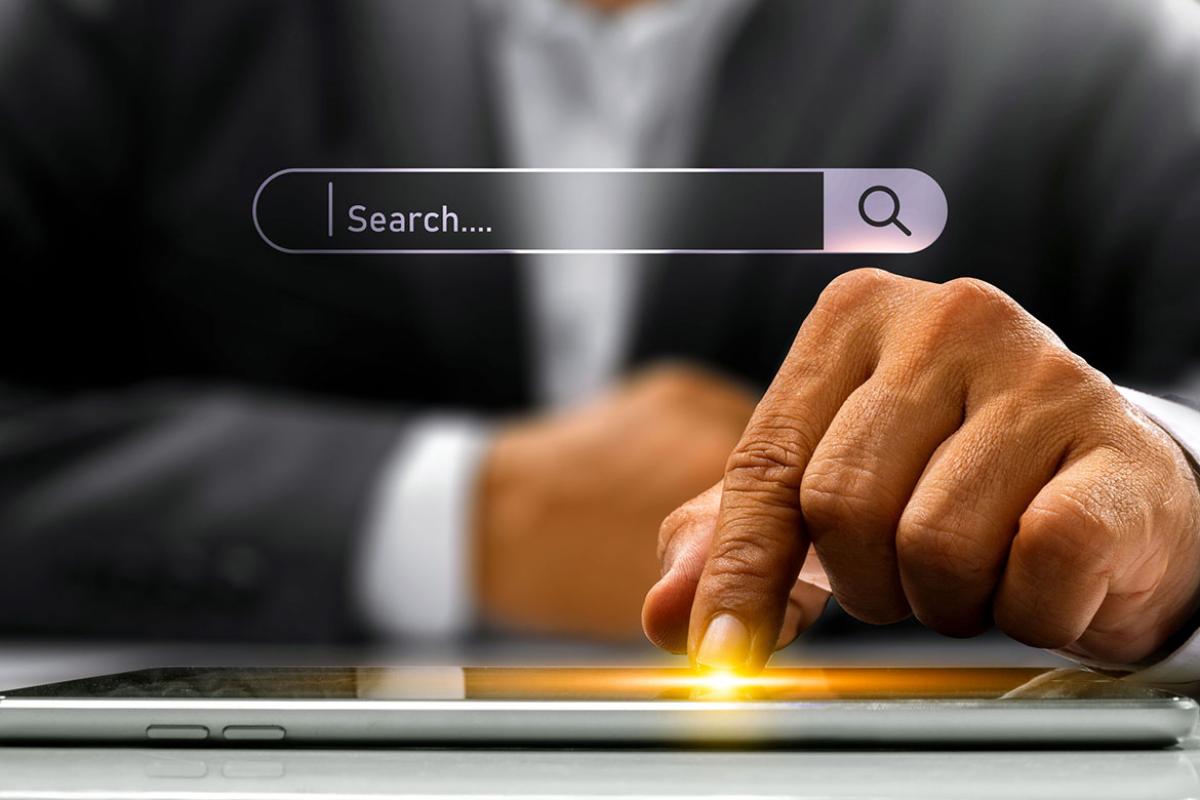 Hand scrolling on a tablet with a search bar hovering above