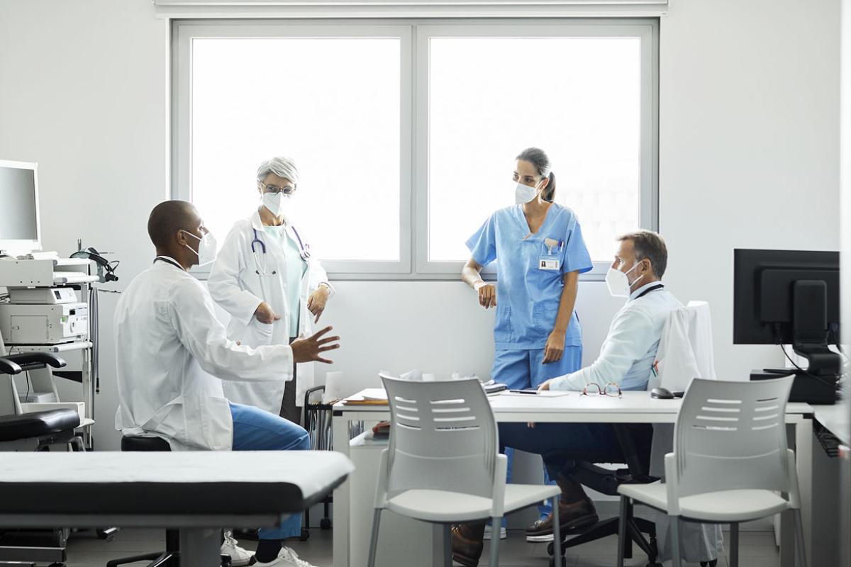 Health care professionals discussing in hospital