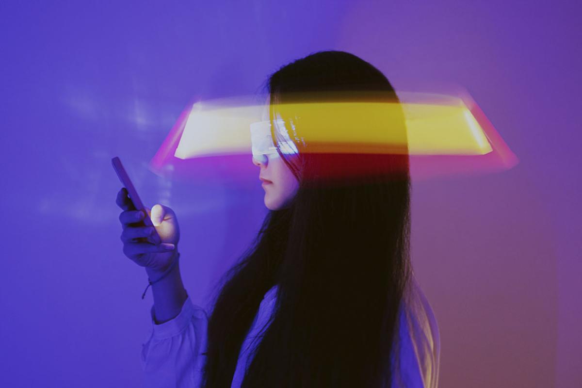 Person holding a smartphone with augmented reality background