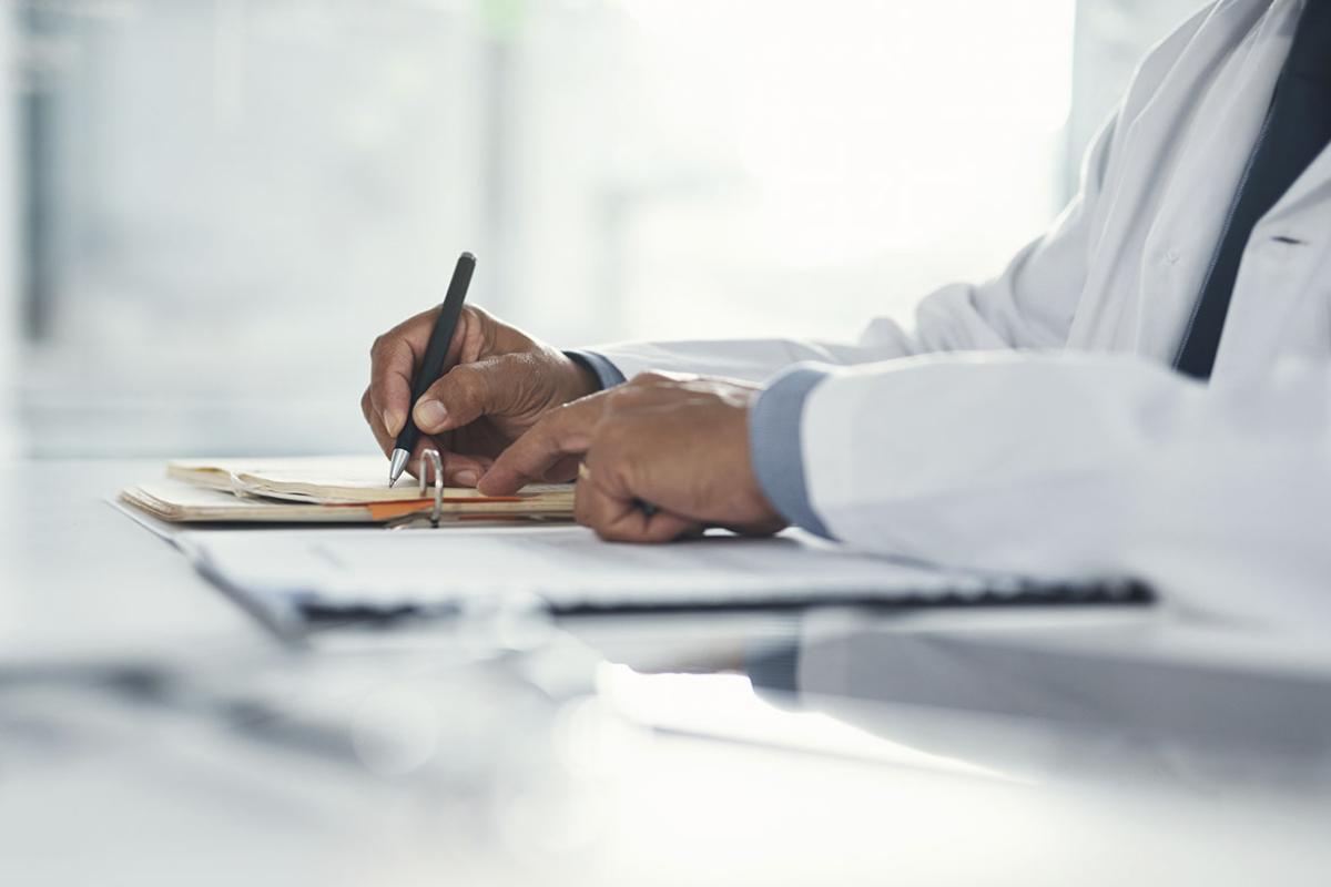 Physician writing down notes