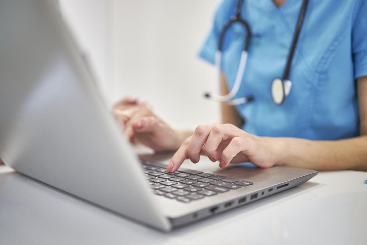 Female physician working at laptop