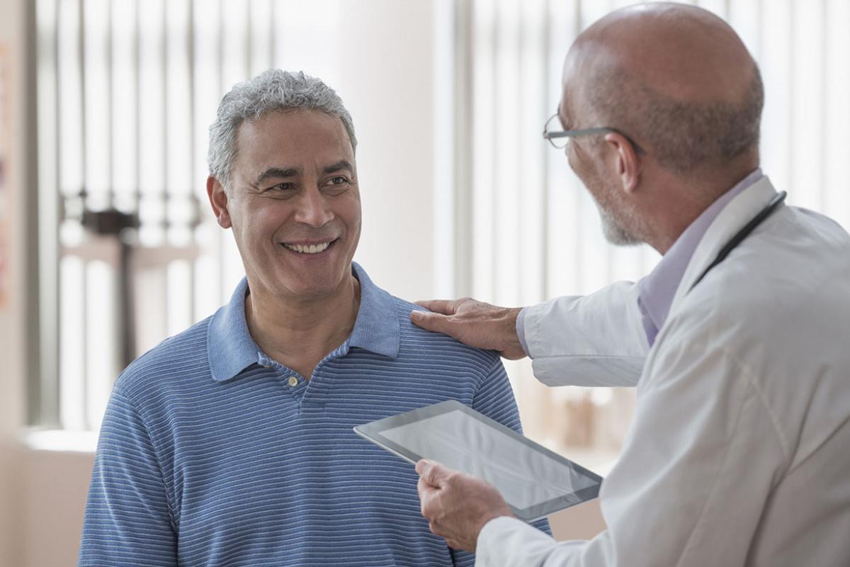 Physician with hand on patient's shoulder