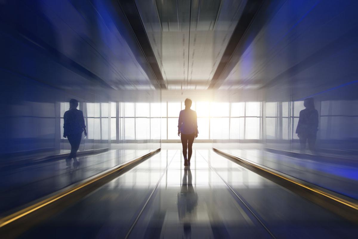 Figure walking in an empty hallway
