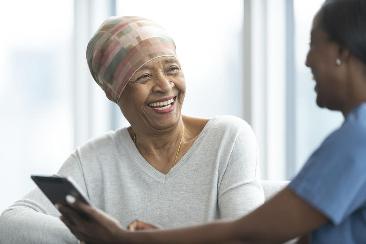 Smiling patient in conversation with health care worker