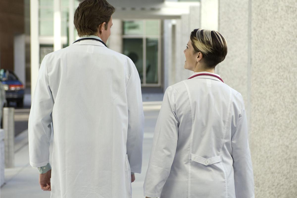 Two physicians in a hallway