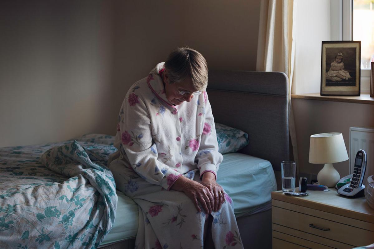 Senior woman sitting on the side of bed