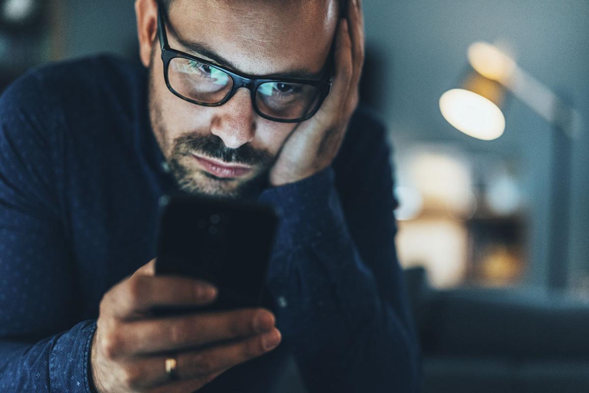 Adult male looking at his phone
