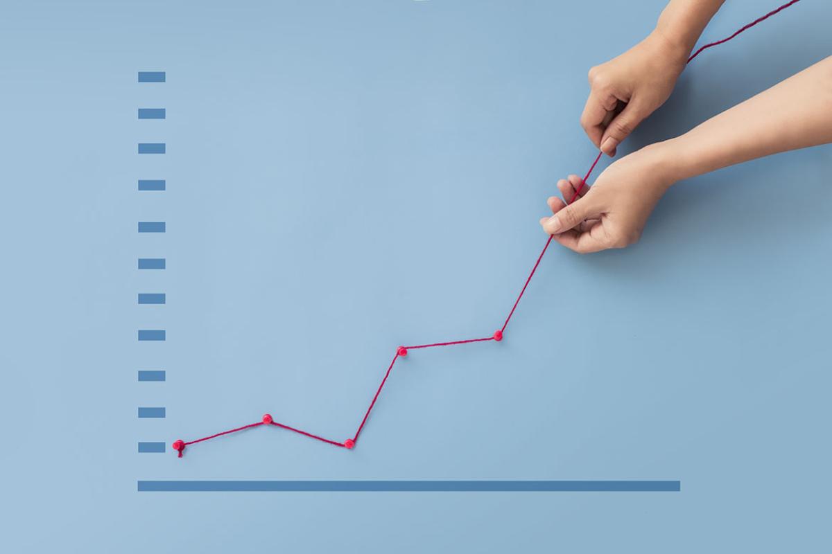 Hands pulling up line on graph