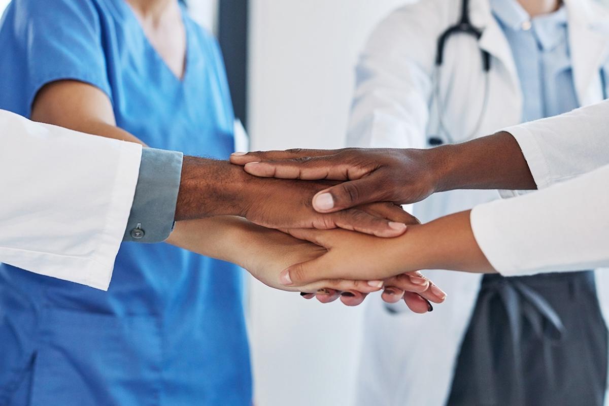 Group of people stacking hands